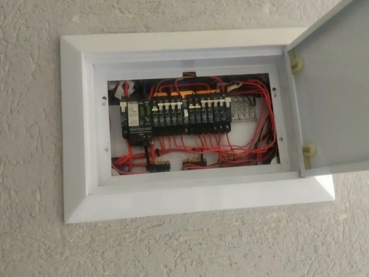 Open distribution board showing circuit breakers and wiring