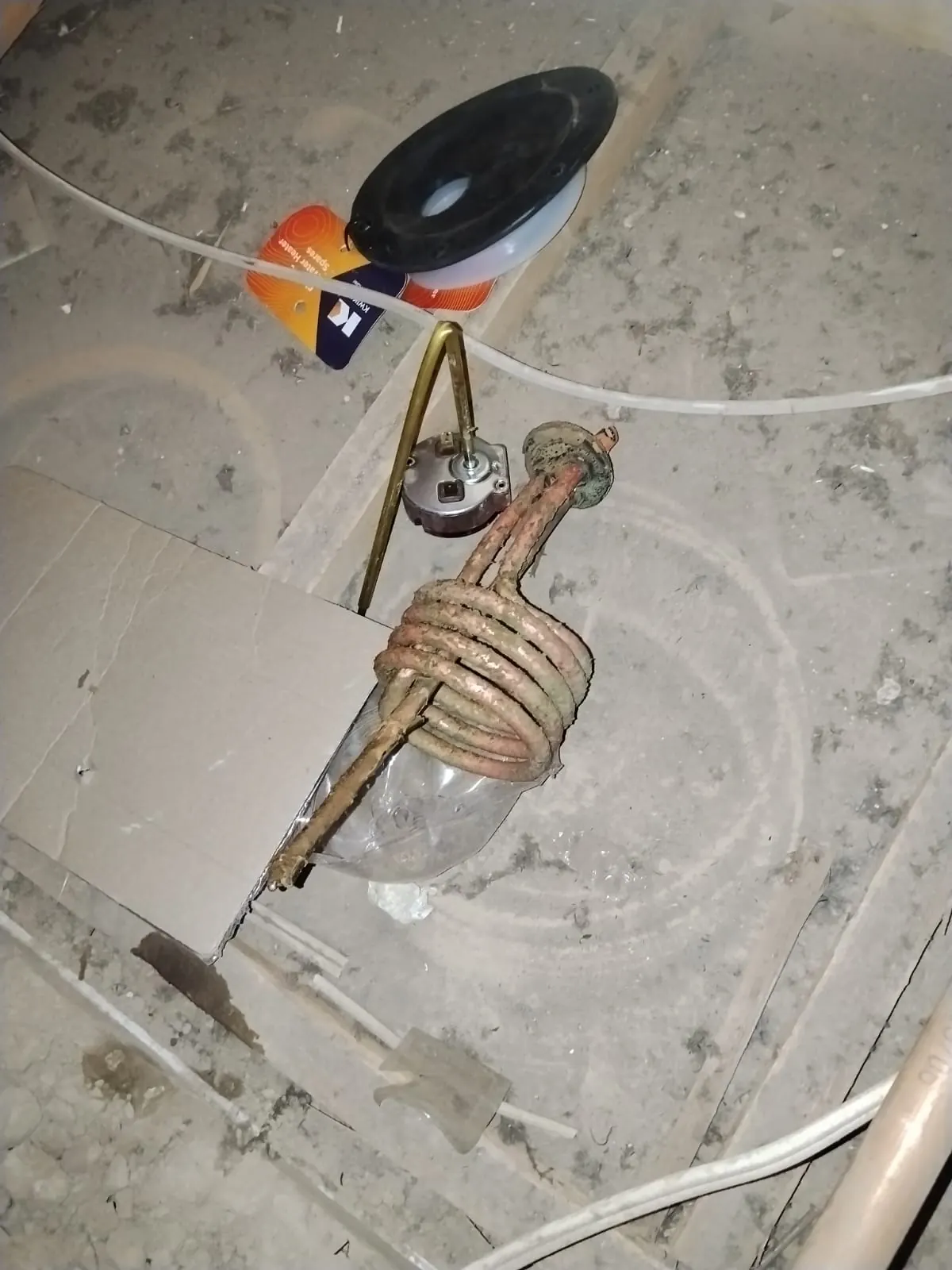 Corroded geyser element and old thermostat removed from a geyser