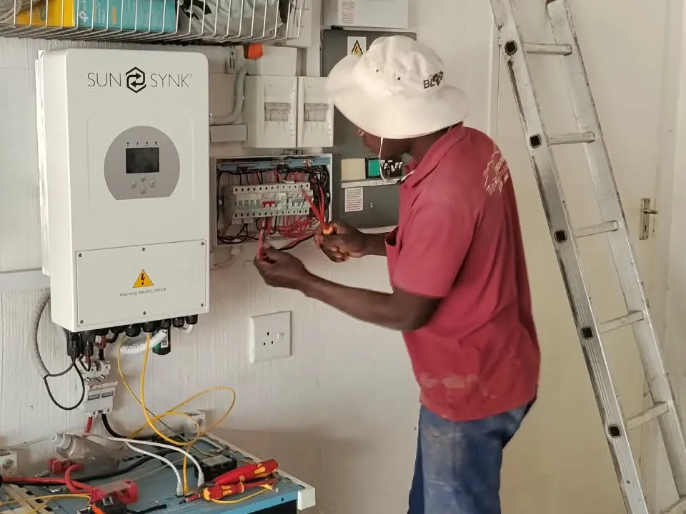 Inverter, batteries and distribution board being wired for backup power