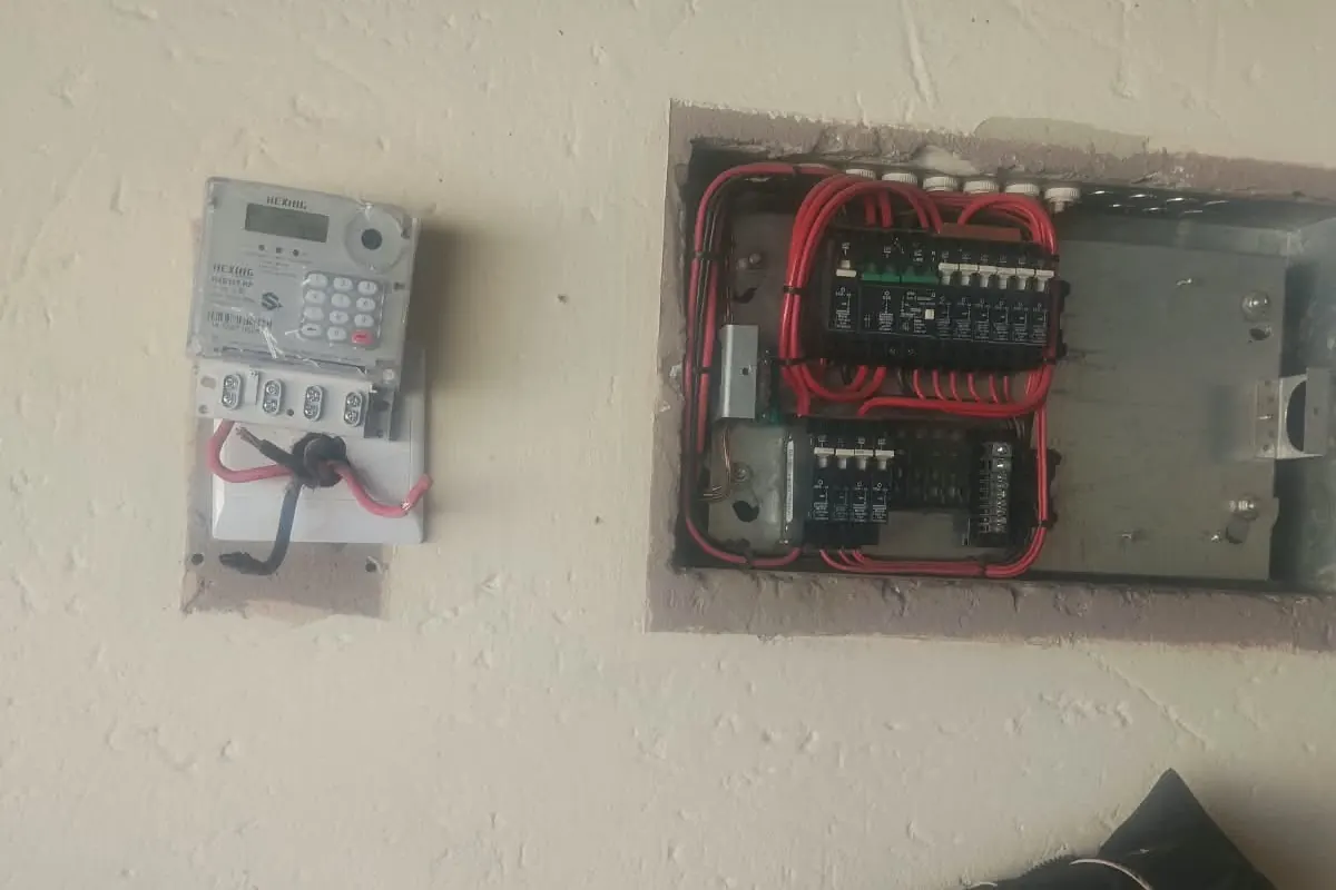 Prepaid electricity meter next to a neatly wired distribution board