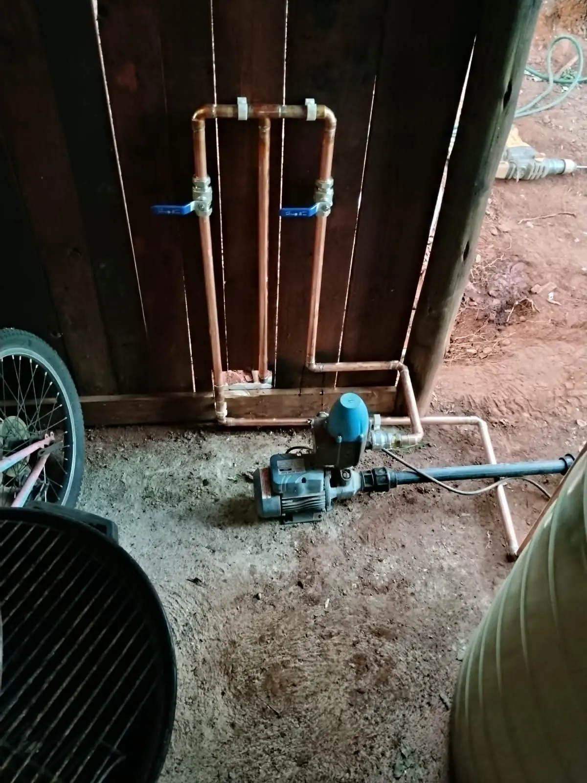 Booster pump connected with copper pipework and isolating valves