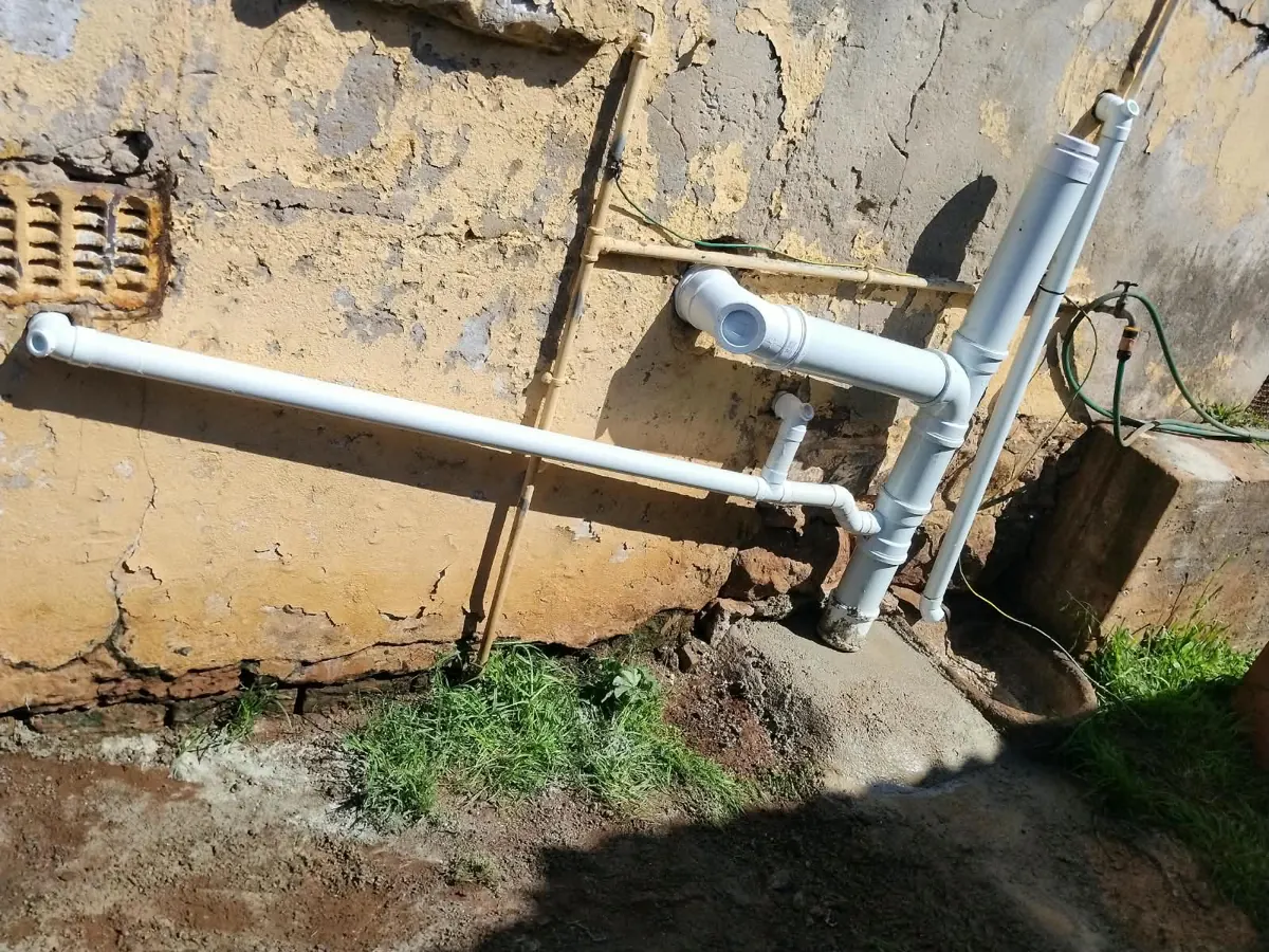 New white PVC waste and vent pipes fitted to an outside wall